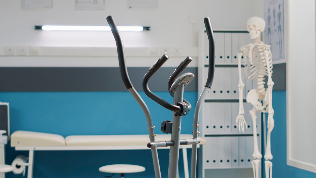 Empty Medical Office With Stationary Bicycle Used At Physical Therapy